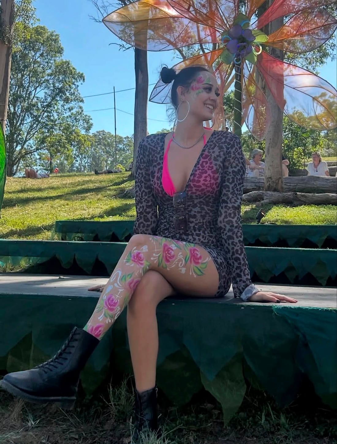 Gaia at a festival, roses painted down her leg and across her face