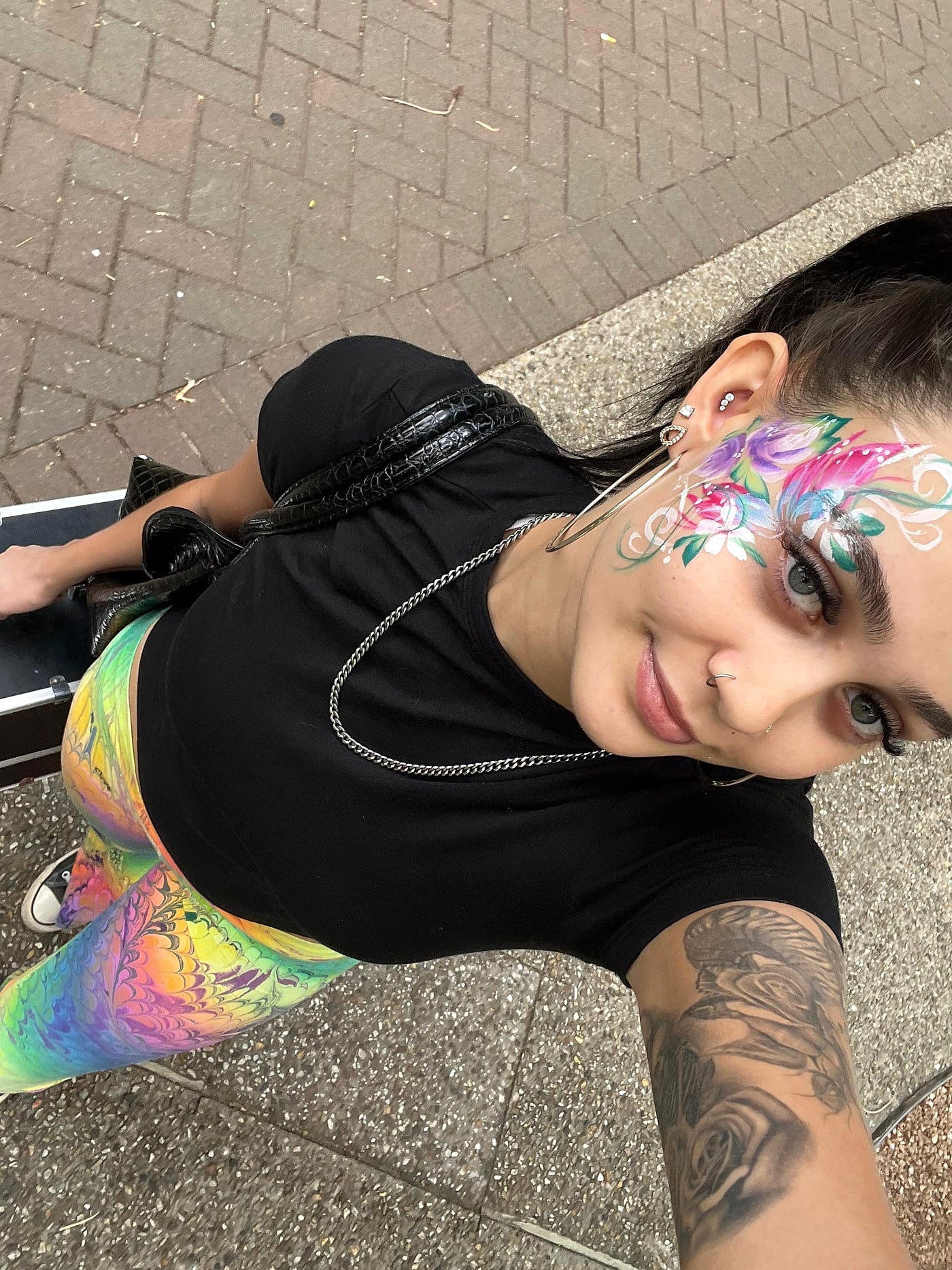 A large floral design painted across a face in bright colour