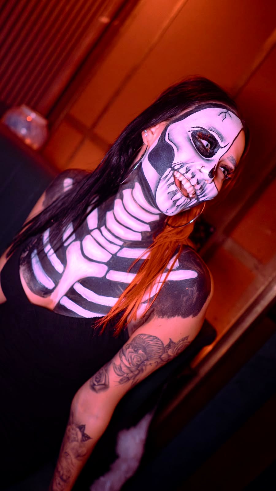 Full skeleton body paint photographed under coloured club lighting