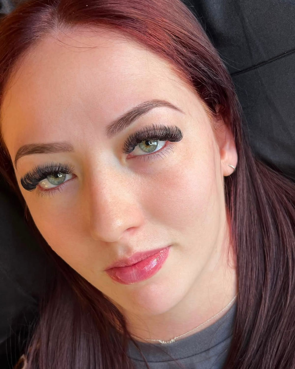 A client after her lash appointment, showing a full set of extensions
