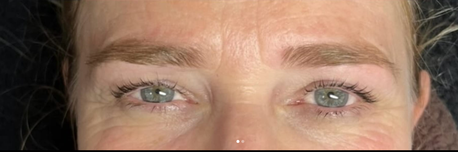 Natural lashes lifted and darkened, with shaped and tinted brows
