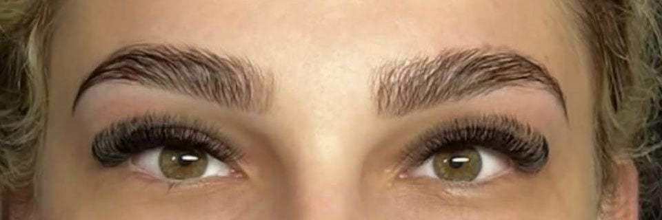 The same brows after shaping and tinting, with lash extensions