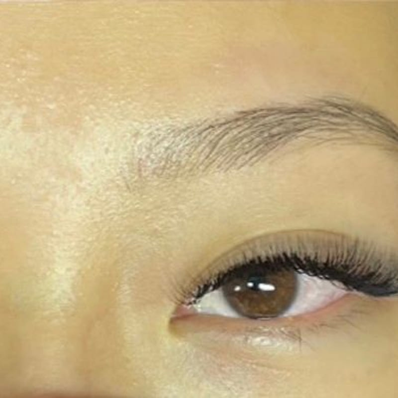 Macro close-up of lash extensions and a shaped brow